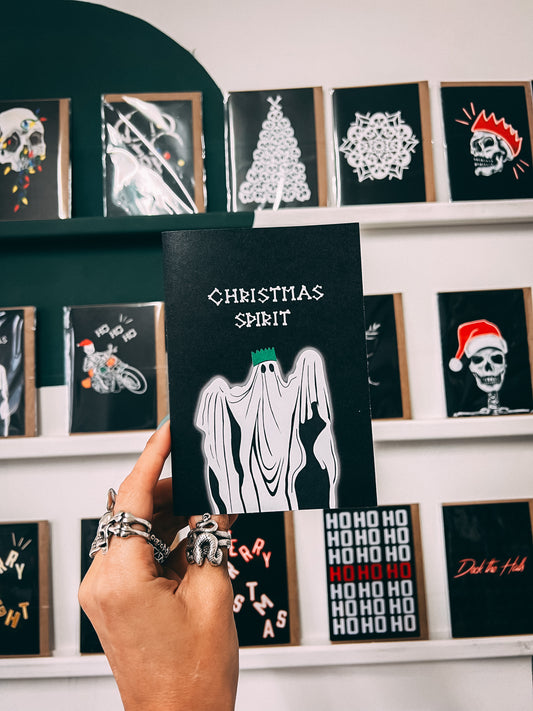Wayward - black christmas card writing in bones with Christmas spirit, underneath illustration of ghost with a christmas hat