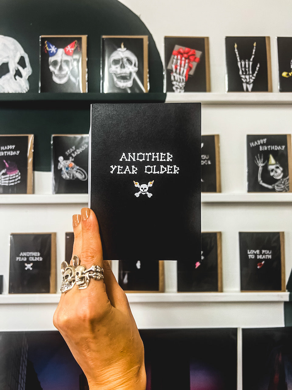 Wayward Another Year Older Gothic Birthday Card text written in bones with a skull and crossbone underneath on a black card