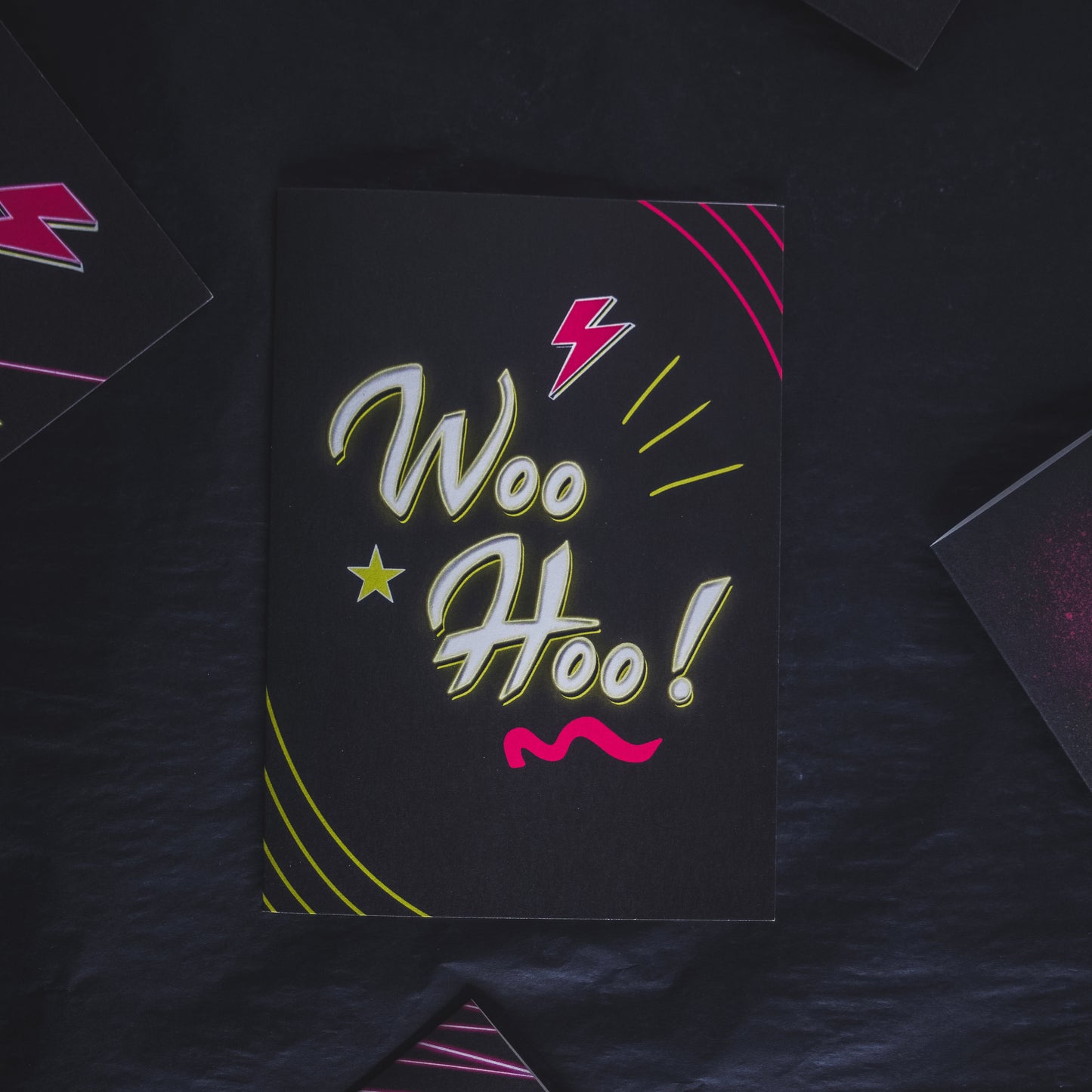 Black Greetings Card With WOO HOO written in white and yellow neon writing by wayward