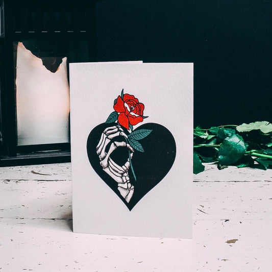 Skeleton Hand Holding red rose illustrated A6 Greetings card by Wayward