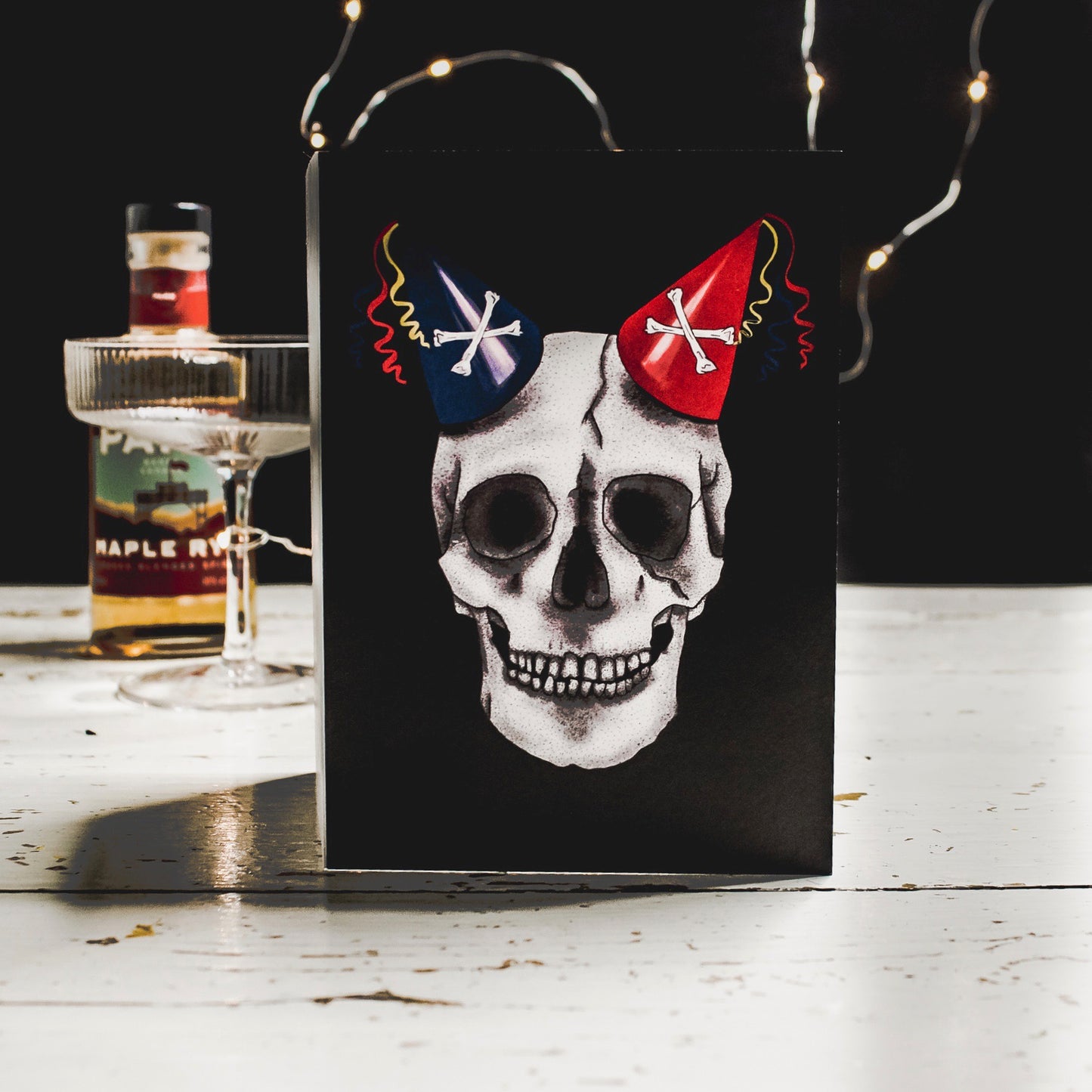 Black Birthday Card with Illustration of skull wearing party hats as horns
