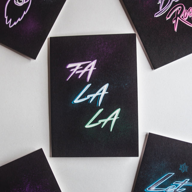 Fa La La neon writing on black background christmas card by wayward