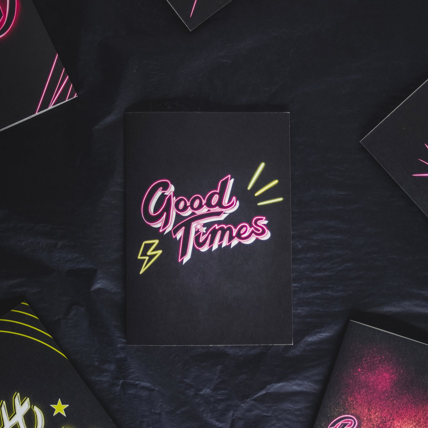 Greetings card with black background and pink Good Times neon writing by Wayward
