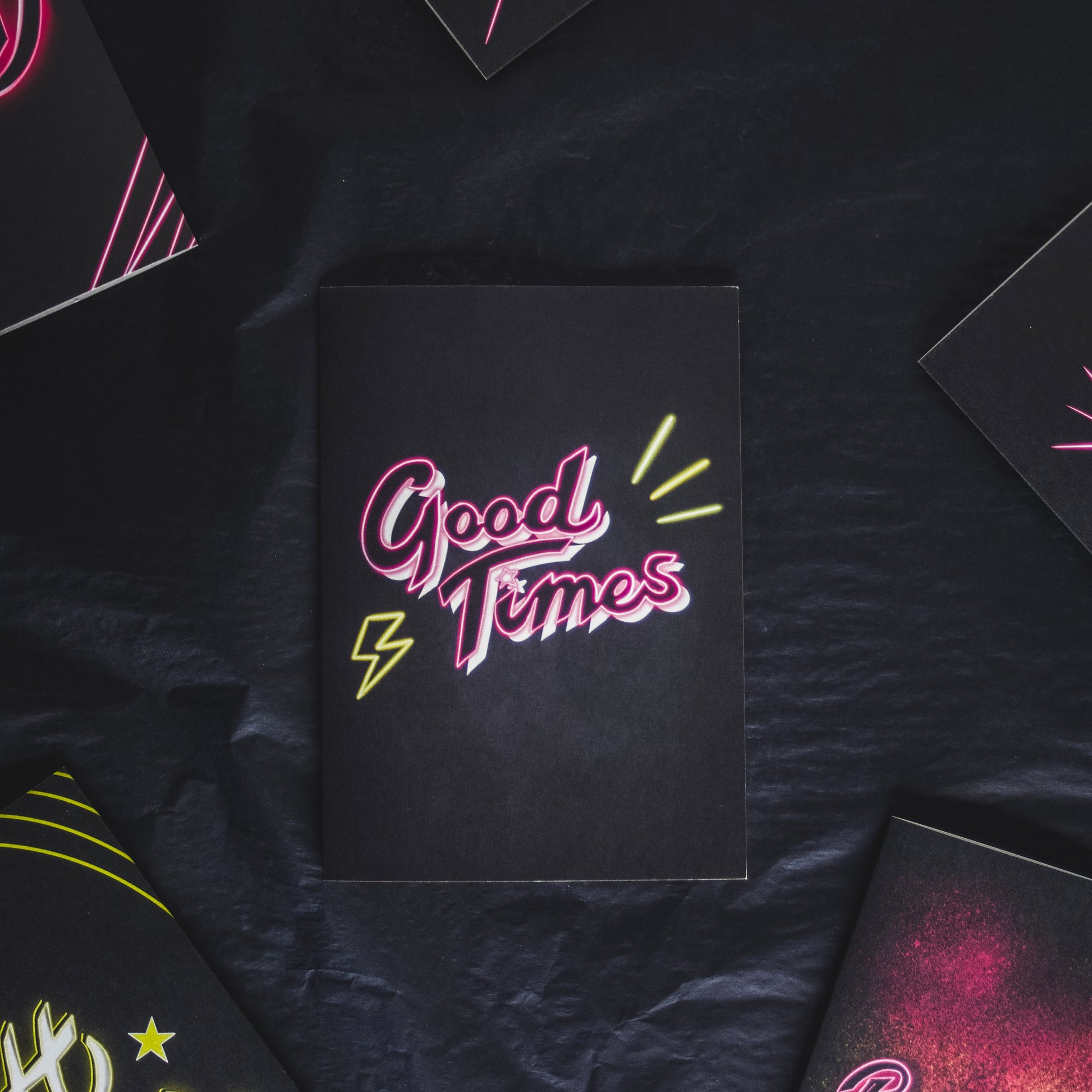 Greetings card with black background and pink Good Times neon writing by Wayward