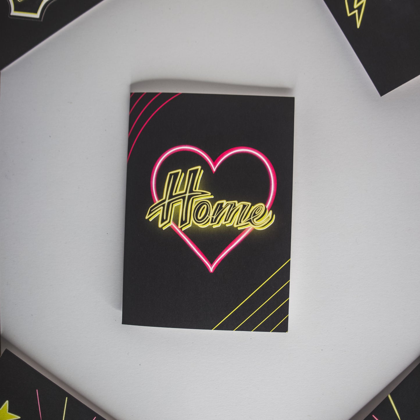 Black Greetings Card With Yellow Home Written in Pink Neon Heart by Wayward