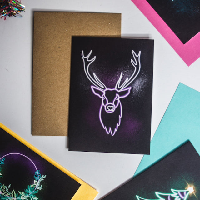 Purple neon stag on black background christmas card by wayward