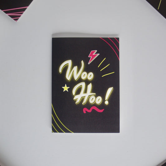 Black Greetings Card With WOO HOO written in white and yellow neon writing by wayward