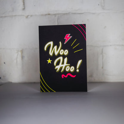 Black Greetings Card With WOO HOO written in white and yellow neon writing by wayward 