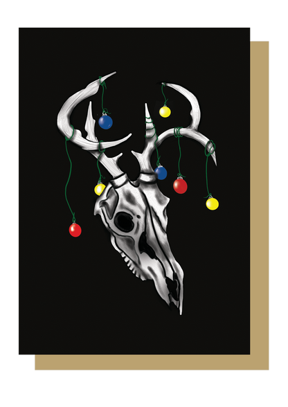 Deer skull with baubles on antlers on black background christmas card by wayward