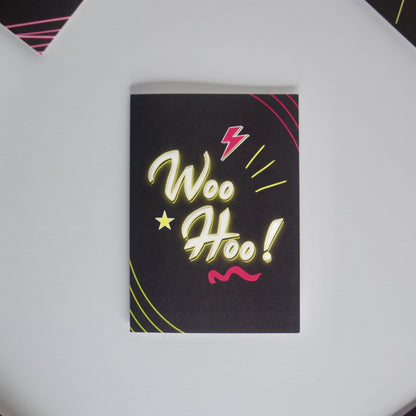 Black Greetings Card With WOO HOO written in white and yellow neon writing by wayward 