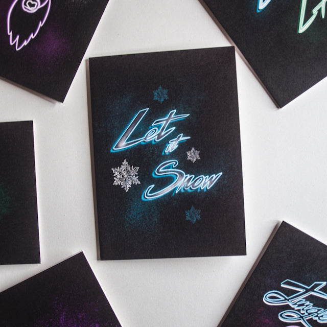 Let is snow neon writing in blue on black background christmas card by wayward